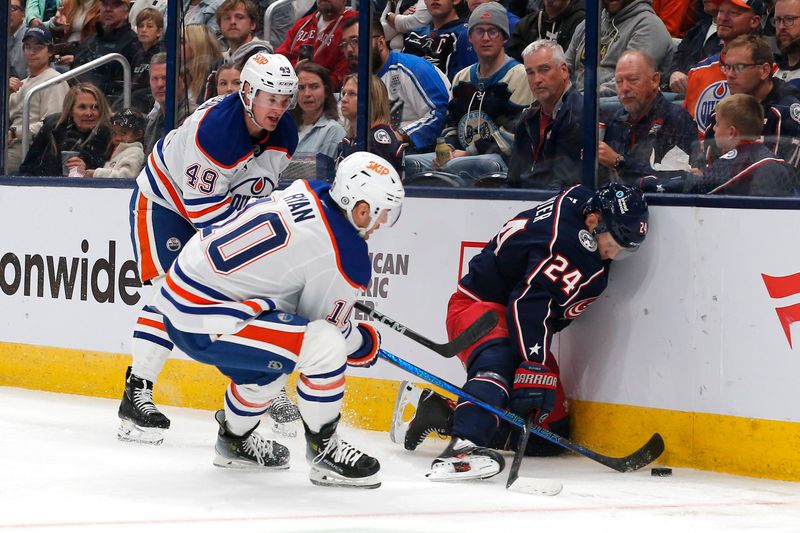 Oct 28, 2024; Columbus, Ohio, USA; Columbus Blue Jackets center Mathieu Olivier (24) and Edmonton Oilers center Derek Ryan (10) battle for a loose puck during the second period at Nationwide Arena. Mandatory Credit: Russell LaBounty-Imagn Images