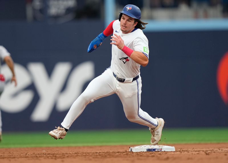 Jun 18, 2024; Toronto, Ontario, CAN; Toronto Blue Jays right fielder Addison Barger (47) rounds second base to score on a single by third baseman Ernie Clement (not pictured) against the Boston Red Sox during the second inning at Rogers Centre. Mandatory Credit: John E. Sokolowski-USA TODAY Sports