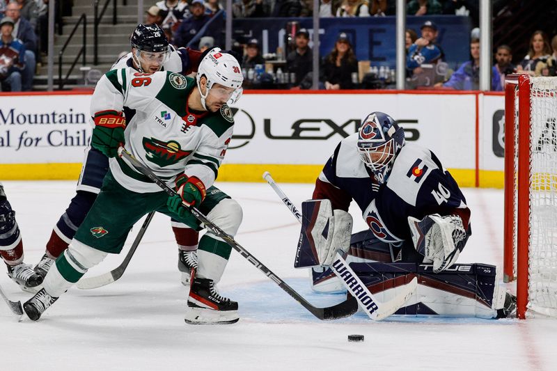 Mar 8, 2024; Denver, Colorado, USA; Minnesota Wild right wing Mats Zuccarello (36) attempts a shot against Colorado Avalanche goaltender Alexandar Georgiev (40) as defenseman Sean Walker (26) defends in the third period at Ball Arena. Mandatory Credit: Isaiah J. Downing-USA TODAY Sports