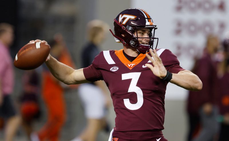 Oct 9, 2021; Blacksburg, Virginia, USA;  Virginia Tech Hokies quarterback Braxton Burmeister (3) throws a warmup pass before the game against the Notre Dame Fighting Irish at Lane Stadium. Mandatory Credit: Reinhold Matay-USA TODAY Sports