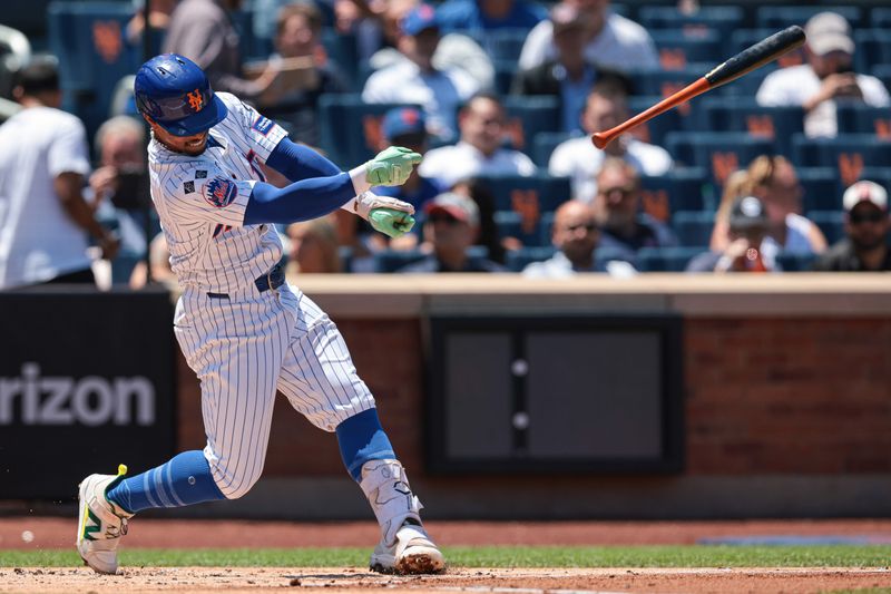 Jul 11, 2024; New York City, New York, USA; New York Mets shortstop Francisco Lindor (12) loses control of the bal during a swing during the first inning against the Washington Nationals at Citi Field. Mandatory Credit: Vincent Carchietta-USA TODAY Sports