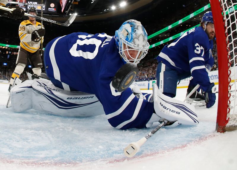 Mar 7, 2024; Boston, Massachusetts, USA; Toronto Maple Leafs goaltender Joseph Woll (60) looks back to see a sahot by Boston Bruins right wing David Pastrnak (88) go in the net for a goal during the first period at TD Garden. Mandatory Credit: Winslow Townson-USA TODAY Sports