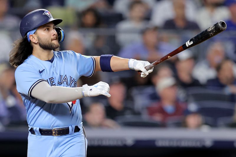 Sep 19, 2023; Bronx, New York, USA; Toronto Blue Jays shortstop Bo Bichette (11) follows through on a two run home run against the New York Yankees during the fifth inning at Yankee Stadium. Mandatory Credit: Brad Penner-USA TODAY Sports