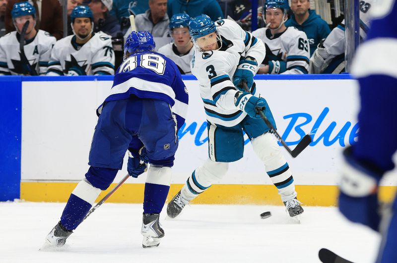 Jan 20, 2026; Tampa, Florida, USA; San Jose Sharks defenseman John Klingberg (3) shoots as Tampa Bay Lightning left wing Brandon Hagel (38) defends during the second period at Benchmark International Arena. Mandatory Credit: Kim Klement Neitzel-Imagn Images