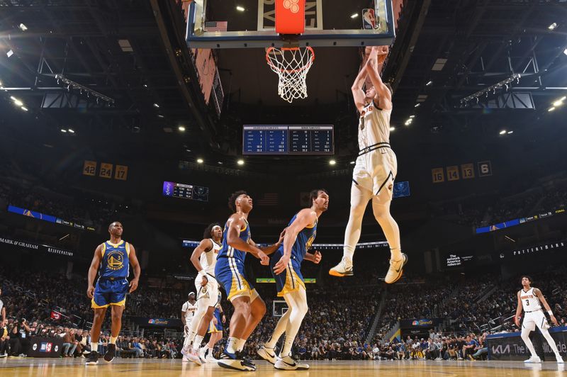 SAN FRANCISCO, CA - JANUARY 4: Christian Braun #0 of the Denver Nuggets drives to the basket during the game against the Golden State Warriors on January 4, 2024 at Chase Center in San Francisco, California. NOTE TO USER: User expressly acknowledges and agrees that, by downloading and or using this photograph, user is consenting to the terms and conditions of Getty Images License Agreement. Mandatory Copyright Notice: Copyright 2024 NBAE (Photo by Noah Graham/NBAE via Getty Images)