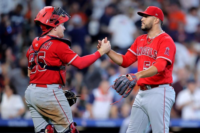 Aug 13, 2023; Houston, Texas, USA; Los Angeles Angels catcher Chad Wallach (35) congratulates Los Angeles Angels relief pitcher Carlos Estevez (53) after the final out against the Houston Astros during the ninth inning at Minute Maid Park. Mandatory Credit: Erik Williams-USA TODAY Sports