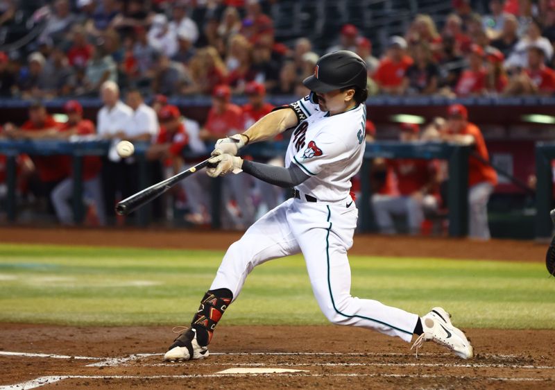 Aug 27, 2023; Phoenix, Arizona, USA; Arizona Diamondbacks outfielder Corbin Carroll hits a single in the third inning against the Cincinnati Reds at Chase Field. Mandatory Credit: Mark J. Rebilas-USA TODAY Sports