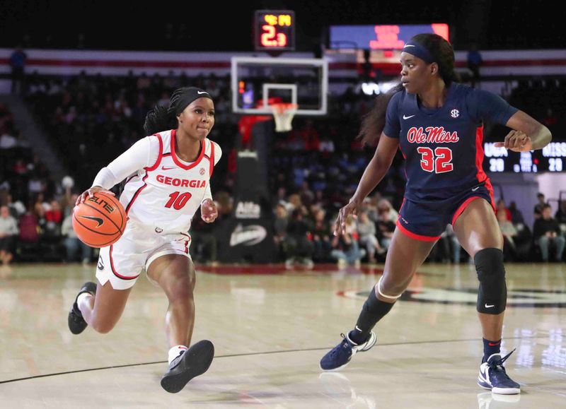 Jan 21, 2024; Athens, Georgia, USA; Georgia Bulldogs guard De   Mauri Flournoy (10) dribbles against Ole Miss Rebels center Rita Igbokwe (32) during the second half at Stegeman Coliseum. Mandatory Credit: Mady Mertens-USA TODAY Sports