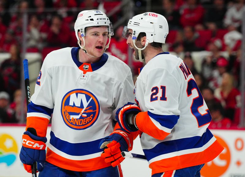 Apr 22, 2024; Raleigh, North Carolina, USA; New York Islanders center Kyle Palmieri (21) talks to center Kyle MacLean (32) during the third period in game two of the first round of the 2024 Stanley Cup Playoffs at PNC Arena. Mandatory Credit: James Guillory-USA TODAY Sports