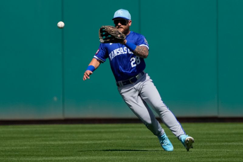 Mar 10, 2024; Mesa, Arizona, USA; Kansas City Royals center fielder Kyle Isbel (28) makes a play on the ball against the Oakland Athletics in the second inning at Hohokam Stadium. Mandatory Credit: Rick Scuteri-USA TODAY Sports