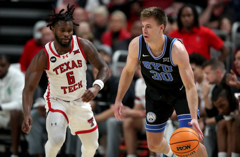 Jan 20, 2024; Lubbock, Texas, USA;  Brigham Young Cougars guard Dallin Hall (30) dribbles the ball against Texas Tech Red Raiders guard Joe Toussaint (6) in the first half at United Supermarkets Arena. Mandatory Credit: Michael C. Johnson-USA TODAY Sports