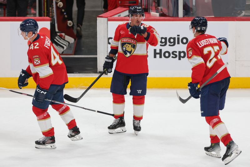 Oct 7, 2025; Sunrise, Florida, USA; Florida Panthers left wing Brad Marchand (63) celebrates with center Eetu Luostarinen (27) after the game against the Chicago Blackhawks at Amerant Bank Arena. Mandatory Credit: Sam Navarro-Imagn Images