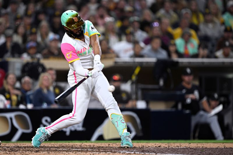 Sep 20, 2024; San Diego, California, USA; San Diego Padres right fielder Fernando Tatis Jr. (23) hits a walk-off double during the tenth inning against the Chicago White Sox at Petco Park. Mandatory Credit: Orlando Ramirez-Imagn Images