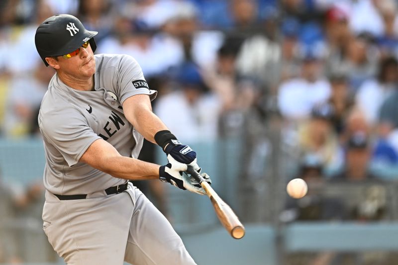 Jun 1, 2025; Los Angeles, California, USA; New York Yankees second baseman DJ LeMahieu (26) hits an RBI single against the Los Angeles Dodgers during the fifth inning at Dodger Stadium. Mandatory Credit: Jonathan Hui-Imagn Images