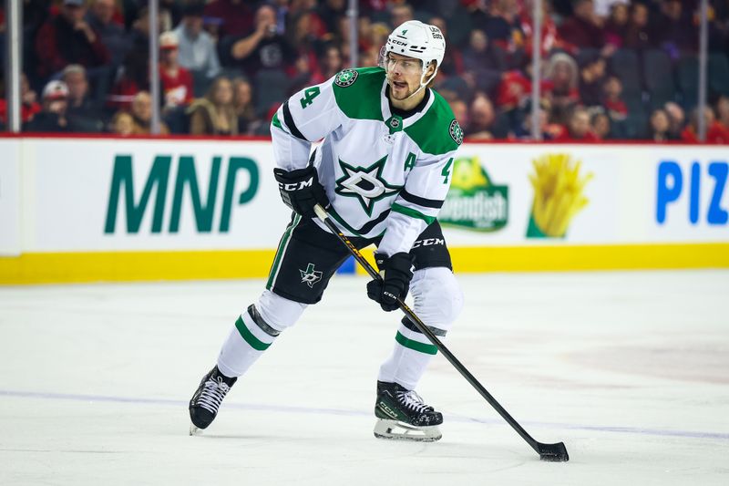 Mar 3, 2026; Calgary, Alberta, CAN; Dallas Stars defenseman Miro Heiskanen (4) controls the puck against the Calgary Flames during the first period at Scotiabank Saddledome. Mandatory Credit: Sergei Belski-Imagn Images