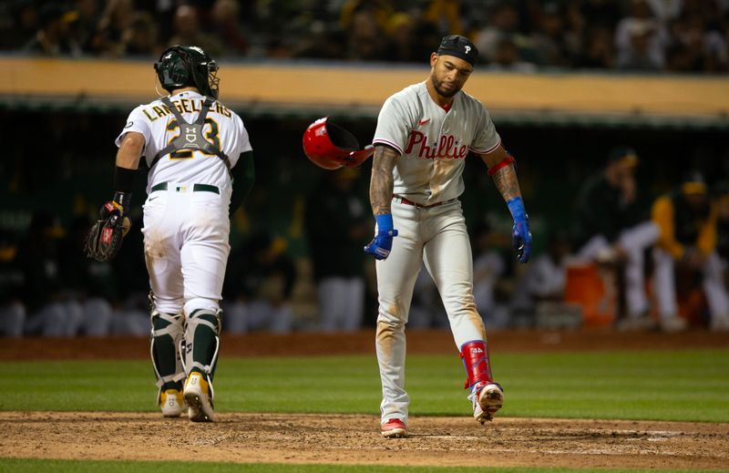 Jun 16, 2023; Oakland, California, USA; Philadelphia Phillies third baseman Edmundo Sosa (33) throws his helmet after striking out against the Oakland Athletics during the ninth inning at Oakland-Alameda County Coliseum. Mandatory Credit: D. Ross Cameron-USA TODAY Sports