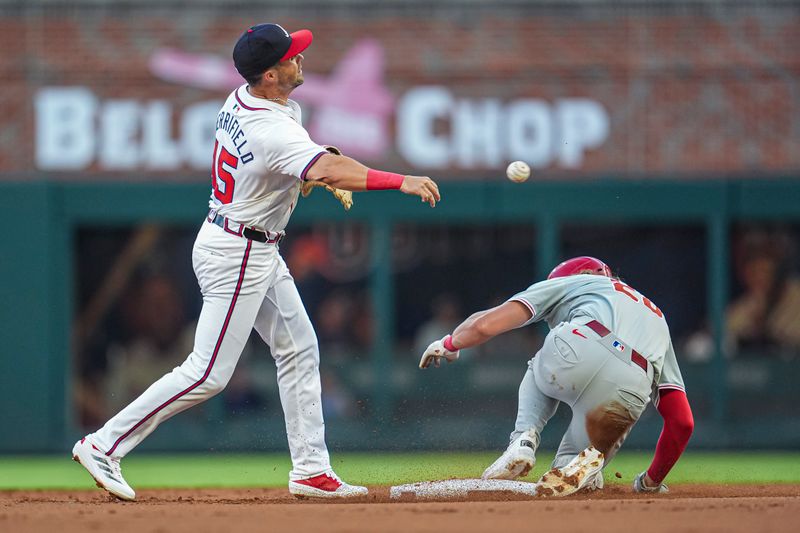 Aug 20, 2024; Cumberland, Georgia, USA; Atlanta Braves left fielder Whit Merrifield (15) tries to turn a double play over Philadelphia Phillies third baseman Alec Bohm (28) during the second inning at Truist Park. Mandatory Credit: Dale Zanine-USA TODAY Sports