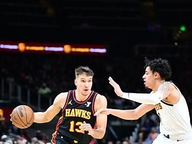 ATLANTA, GA - DECEMBER 11: Bogdan Bogdanovic #13 of the Atlanta Hawks drives to the basket during the game against the Denver Nuggets on December 11, 2023 at State Farm Arena in Atlanta, Georgia.  NOTE TO USER: User expressly acknowledges and agrees that, by downloading and/or using this Photograph, user is consenting to the terms and conditions of the Getty Images License Agreement. Mandatory Copyright Notice: Copyright 2023 NBAE (Photo by Adam Hagy/NBAE via Getty Images)