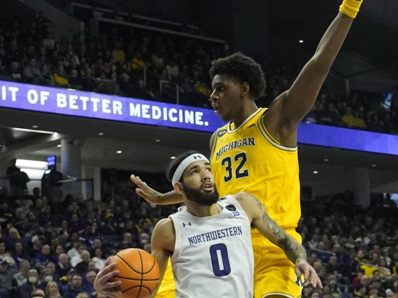 Feb 2, 2023; Evanston, Illinois, USA; Michigan Wolverines forward Tarris Reed Jr. (32) defends Northwestern Wildcats guard Boo Buie (0) during the second half at Welsh-Ryan Arena. Mandatory Credit: David Banks-USA TODAY Sports