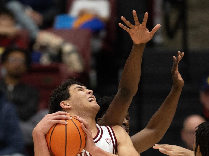 Jan 28, 2023; Stanford, California, USA; Stanford Cardinal forward Brandon Angel (23) grimaces as he tries to drive past California Golden Bears forward Monty Bowser (2) during the first half at Maples Pavilion. Mandatory Credit: D. Ross Cameron-USA TODAY Sports