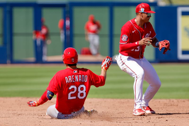 Feb 28, 2023; West Palm Beach, Florida, USA; St. Louis Cardinals third baseman Nolan Arenado (28) slides at second base during the fifth inning against the Washington Nationals at The Ballpark of the Palm Beaches. Mandatory Credit: Sam Navarro-USA TODAY Sports