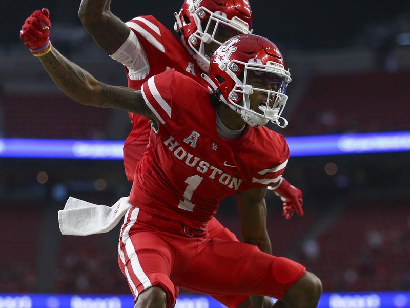 Sep 4, 2021; Houston, Texas, USA; Houston Cougars wide receiver Nathaniel Dell (1) celebrates after making a touchdown reception during the first quarter against the Texas Tech Red Raiders at NRG Stadium. Mandatory Credit: Troy Taormina-USA TODAY Sports