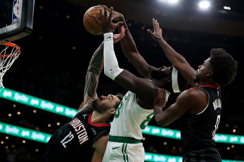 BOSTON, MASSACHUSETTS - JANUARY 27: Steven Adams #12 of the Houston Rockets and Aaron Holiday #0 battle for a rebound with Neemias Queta #88 of the Boston Celtics during the second half at TD Garden on January 27, 2025 in Boston, Massachusetts. The Rockets defeat the Celtics 114-112. NOTE TO USER: User expressly acknowledges and agrees that, by downloading and or using this photograph, User is consenting to the terms and conditions of the Getty Images License Agreement.  (Photo by Maddie Meyer/Getty Images)