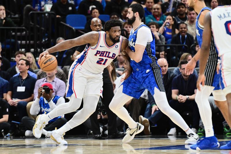 ORLANDO, FLORIDA - JANUARY 19: Joel Embiid #21 of the Philadelphia 76ers drives to the basket against Goga Bitadze #35 of the Orlando Magic in the second half of a game at Kia Center on January 19, 2024 in Orlando, Florida. NOTE TO USER: User expressly acknowledges and agrees that, by downloading and or using this photograph, User is consenting to the terms and conditions of the Getty Images License Agreement. (Photo by Julio Aguilar/Getty Images)