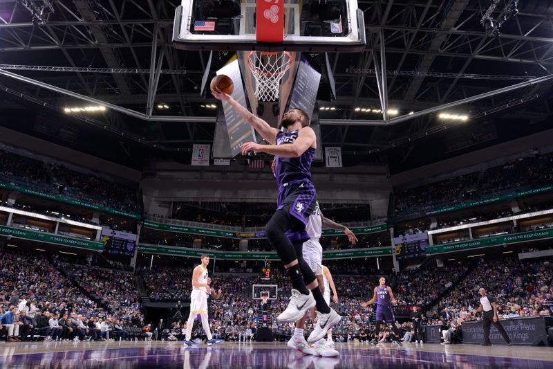 SACRAMENTO, CA - DECEMBER 8: Domantas Sabonis #11 of the Sacramento Kings drives to the basket during the game against the Utah Jazz on December 8, 2024 at Golden 1 Center in Sacramento, California. NOTE TO USER: User expressly acknowledges and agrees that, by downloading and or using this Photograph, user is consenting to the terms and conditions of the Getty Images License Agreement. Mandatory Copyright Notice: Copyright 2024 NBAE (Photo by Rocky Widner/NBAE via Getty Images)