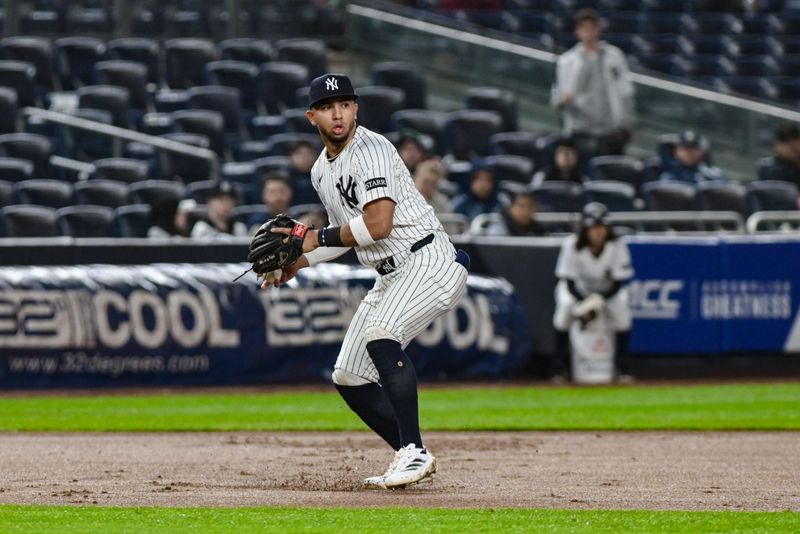 May 5, 2025; Bronx, New York, USA; New York Yankees third baseman Oswald Peraza (18) fields a ground ball hit by San Diego Padres catcher Luis Campusano (not pictured) and throws to second base for an out during the seventh inning at Yankee Stadium. Mandatory Credit: John Jones-Imagn Images