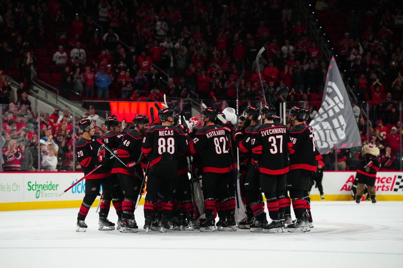 Mar 10, 2024; Raleigh, North Carolina, USA;  Carolina Hurricanes players celebrate their victory against the Calgary Flames at PNC Arena. Mandatory Credit: James Guillory-USA TODAY Sports