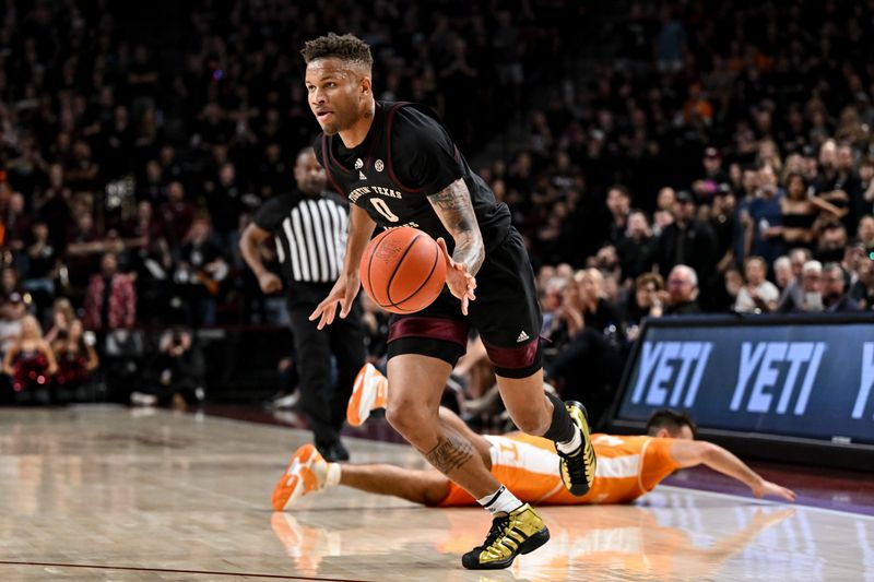 Feb 21, 2023; College Station, Texas, USA; Texas A&M Aggies guard Dexter Dennis (0) drives to the basket during the second half against the Tennessee Volunteers at Reed Arena. Mandatory Credit: Maria Lysaker-USA TODAY Sports