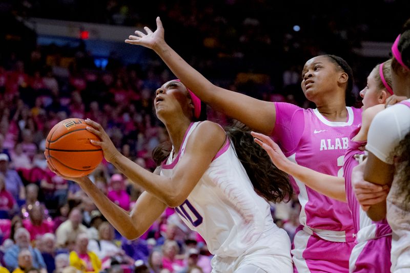 Feb 11, 2024; Baton Rouge, Louisiana, USA; LSU Lady Tigers forward Angel Reese (10) shoots against Alabama Crimson Tide guard Jessica Timmons (23) during the first half at Pete Maravich Assembly Center. Mandatory Credit: Matthew Hinton-USA TODAY Sports