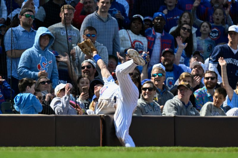 May 31, 2025; Chicago, Illinois, USA;  Chicago Cubs third baseman Matt Shaw (6) tries to make the play on the fly ball hit by Cincinnati Reds outfielder TJ Friedl (29) during the ninth inning at Wrigley Field. Mandatory Credit: Matt Marton-Imagn Images