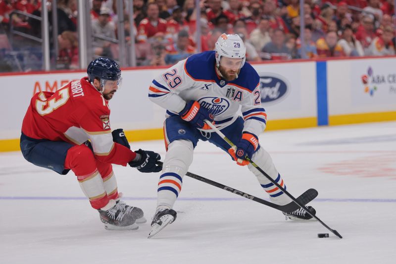 Jun 9, 2025; Sunrise, Florida, USA; Edmonton Oilers center Leon Draisaitl (29) controls the puck against Florida Panthers forward Sam Reinhart (13) during the first period in game three of the 2025 Stanley Cup Final at Amerant Bank Arena. Mandatory Credit: Sam Navarro-Imagn Images