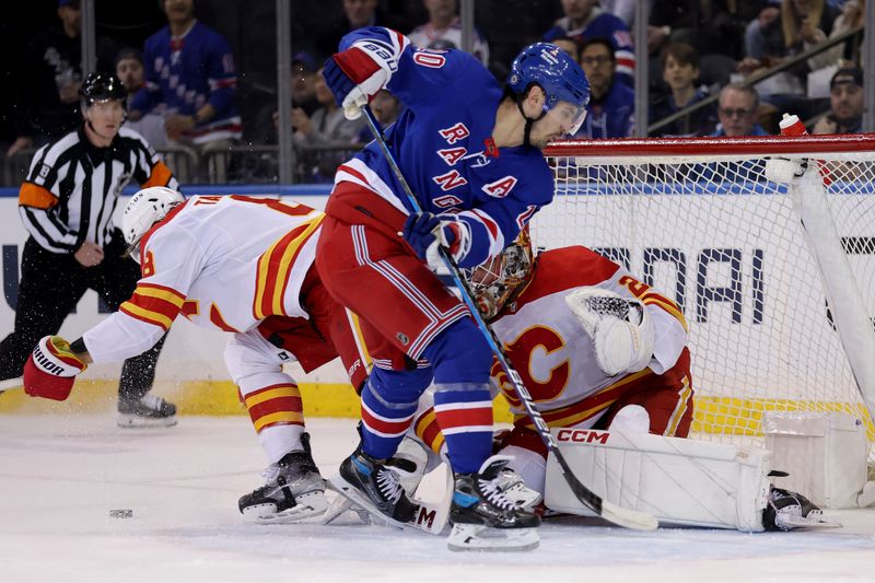 Feb 12, 2024; New York, New York, USA; New York Rangers left wing Chris Kreider (20) fights for the puck against Calgary Flames defenseman Chris Tanev (8) and goaltender Jacob Markstrom (25) during the first period at Madison Square Garden. Mandatory Credit: Brad Penner-USA TODAY Sports