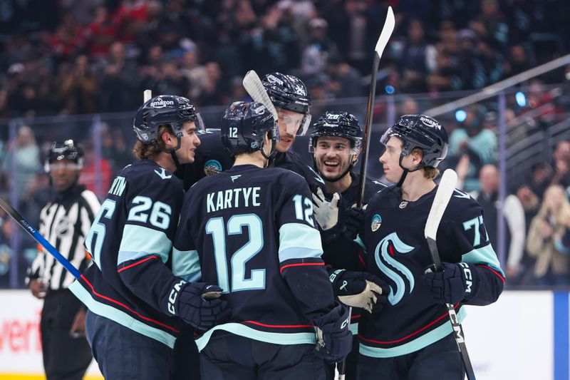 Nov 3, 2025; Seattle, Washington, USA; Seattle Kraken surround defenseman Jamie Oleksiak (24) after he scores in the second period against the Chicago Blackhawks at Climate Pledge Arena. Mandatory Credit: Kevin Ng-Imagn Images