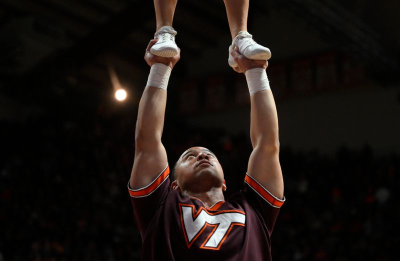 Feb 4, 2023; Blacksburg, Virginia, USA; A Virginia Tech Hokies cheerleader stays focused during a routine during game against the Virginia Cavaliers at Cassell Coliseum. Mandatory Credit: Lee Luther Jr.-USA TODAY Sports