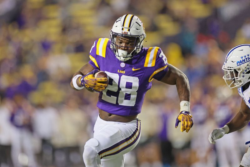 Nov 18, 2023; Baton Rouge, Louisiana, USA; LSU Tigers running back Kaleb Jackson (28) runs for yardage as Georgia State Panthers safety Jeremiah Johnson (6) pursues him in the third quarter at Tiger Stadium. Mandatory Credit: Matthew Dobbins-USA TODAY Sports