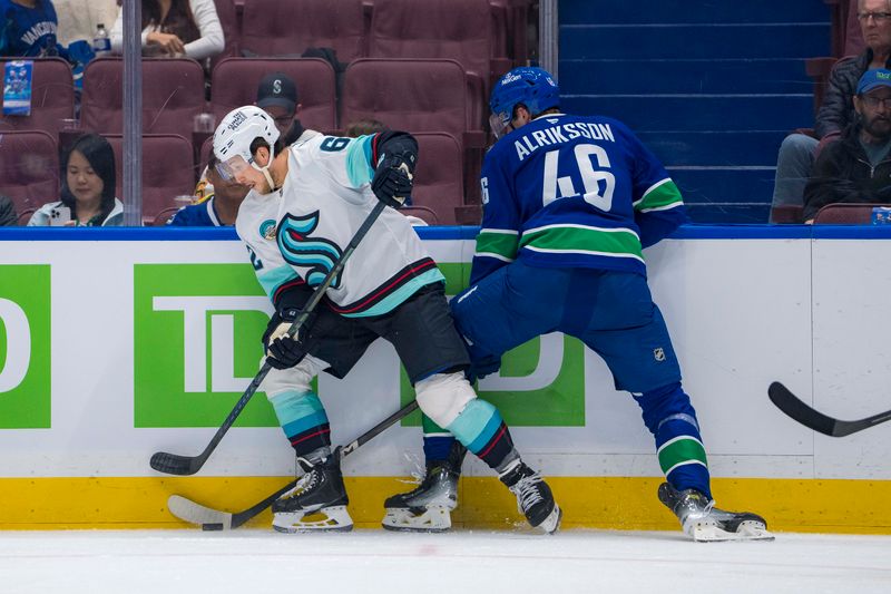 Sep 24, 2024; Vancouver, British Columbia, CAN; Vancouver Canucks forward Vilmer Alriksson (46) checks Seattle Kraken defenseman Brandon Montour (62) during the second period at Rogers Arena. Mandatory Credit: Bob Frid-Imagn Images