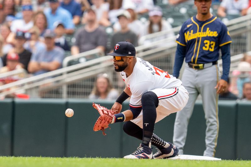 Jul 21, 2024; Minneapolis, Minnesota, USA; Minnesota Twins first base Carlos Santana (30) catches the throw from second baseman Edouard Julien (47) to retire Milwaukee Brewers designated hitter William Contreras (24) at Target Field. Mandatory Credit: Matt Blewett-USA TODAY Sports