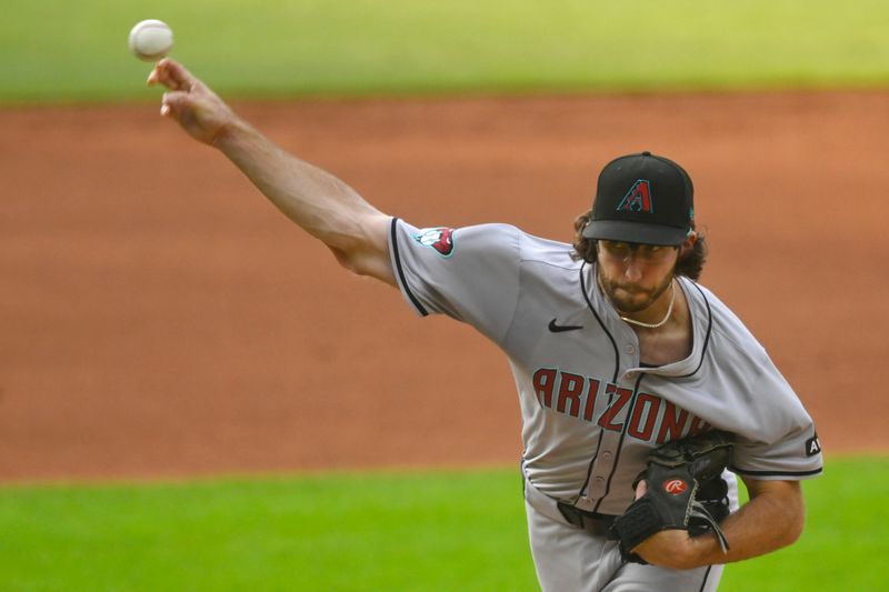 Aug 5, 2024; Cleveland, Ohio, USA; Arizona Diamondbacks starting pitcher Zac Gallen (23) delivers a pitch in the first inning against the Cleveland Guardians at Progressive Field. Mandatory Credit: David Richard-USA TODAY Sports