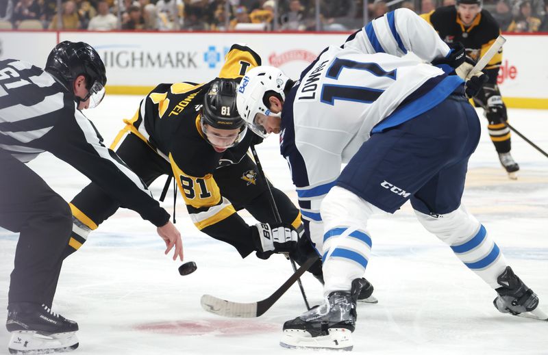 Mar 21, 2026; Pittsburgh, Pennsylvania, USA;  Pittsburgh Penguins center Ben Kindel (81) and Winnipeg Jets center Adam Lowry (17) take a first period face-off at PPG Paints Arena. Mandatory Credit: Charles LeClaire-Imagn Images