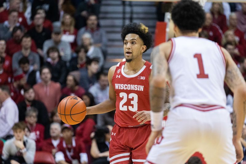 Jan 14, 2023; Bloomington, Indiana, USA; Wisconsin Badgers guard Chucky Hepburn (23) dribbles the ball while Indiana Hoosiers guard Jalen Hood-Schifino (1) defends in the second half at Simon Skjodt Assembly Hall. Mandatory Credit: Trevor Ruszkowski-USA TODAY Sports