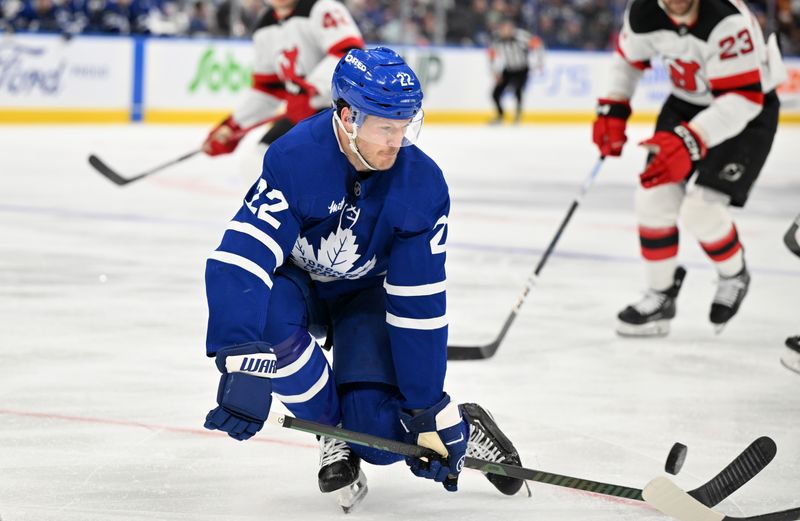 Jan 16, 2025; Toronto, Ontario, CAN;  Toronto Maple Leafs defenseman Jake McCabe (22) breaks up a passing play against the New Jersey Devils in the second period at Scotiabank Arena. Mandatory Credit: Dan Hamilton-Imagn Images