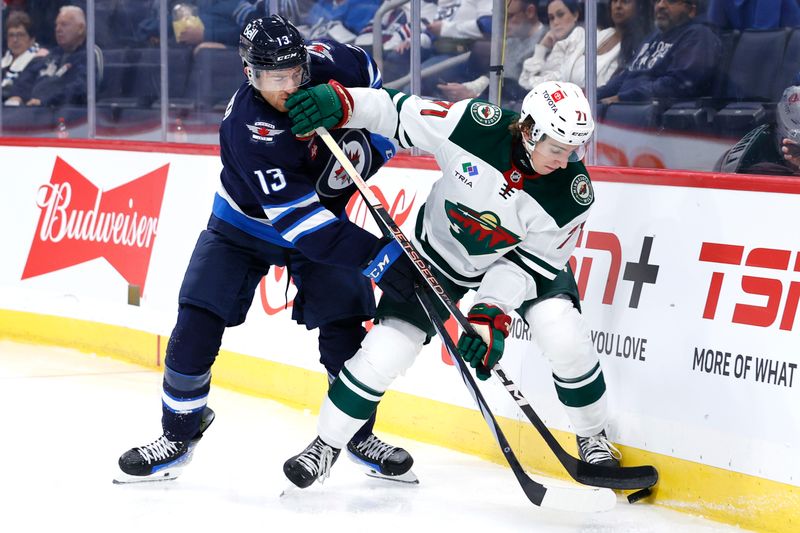 Sep 21, 2024; Winnipeg, Manitoba, CAN; Minnesota Wild defenseman Carson Lambos (71) is checked by Winnipeg Jets center Gabriel Vilardi (13) in the second period at Canada Life Centre. Mandatory Credit: James Carey Lauder-Imagn Images