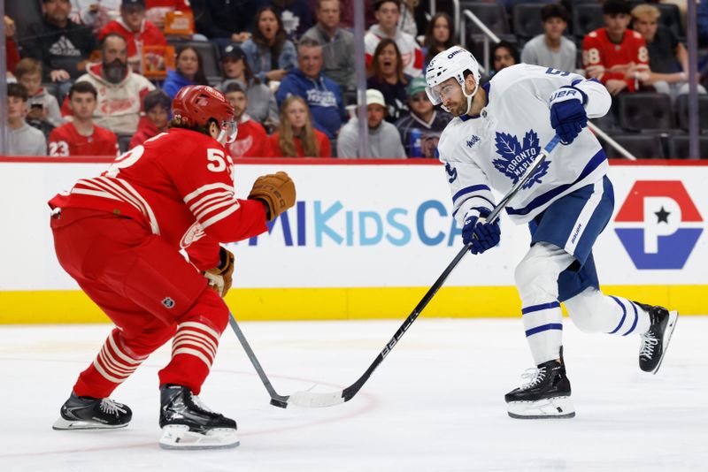 Oct 11, 2025; Detroit, Michigan, USA;  Toronto Maple Leafs center Nicolas Roy (55) takes a shot defended by Detroit Red Wings defenseman Moritz Seider (53) in the third period at Little Caesars Arena. Mandatory Credit: Rick Osentoski-Imagn Images