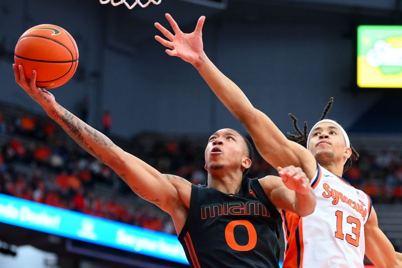 Jan 20, 2024; Syracuse, New York, USA; Miami (Fl) Hurricanes guard Matthew Cleveland (0) shoots the ball against the defense of Syracuse Orange forward Benny Williams (13) during the first half at the JMA Wireless Dome. Mandatory Credit: Rich Barnes-USA TODAY Sports