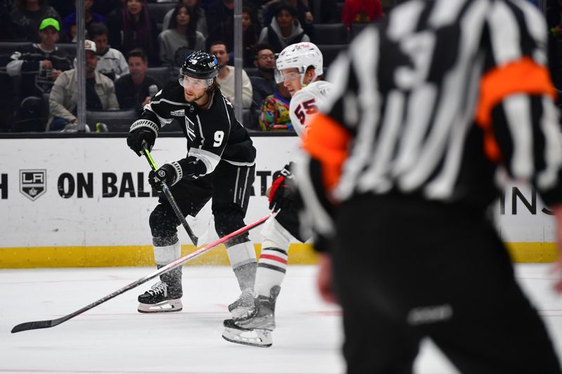 Apr 18, 2024; Los Angeles, California, USA; Los Angeles Kings right wing Adrian Kempe (9) scores a goal against the defense of Chicago Blackhawks defenseman Kevin Korchinski (55) during the overtime period at Crypto.com Arena. Mandatory Credit: Gary A. Vasquez-USA TODAY Sports