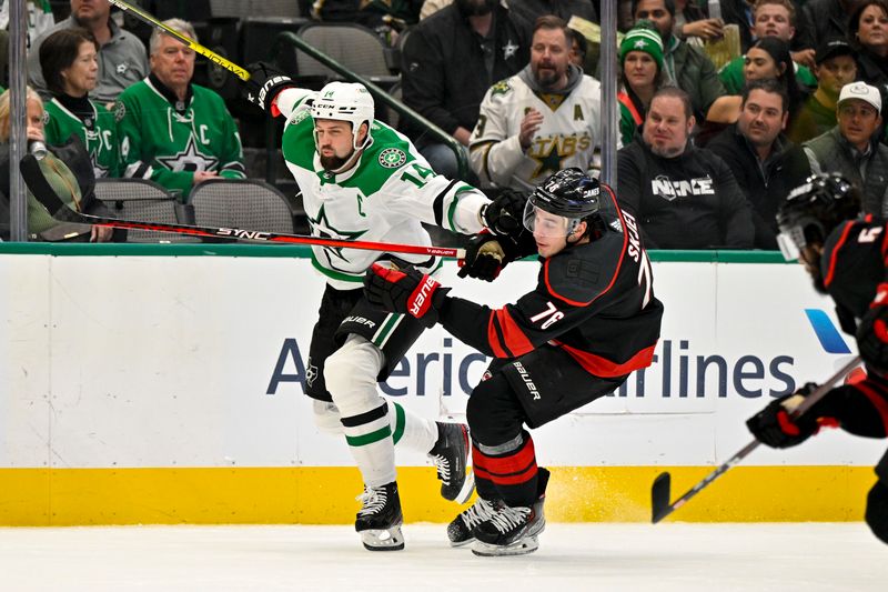 Jan 25, 2023; Dallas, Texas, USA; Dallas Stars left wing Jamie Benn (14) and Carolina Hurricanes defenseman Brady Skjei (76) chase the puck during the second period at the American Airlines Center. Mandatory Credit: Jerome Miron-USA TODAY Sports